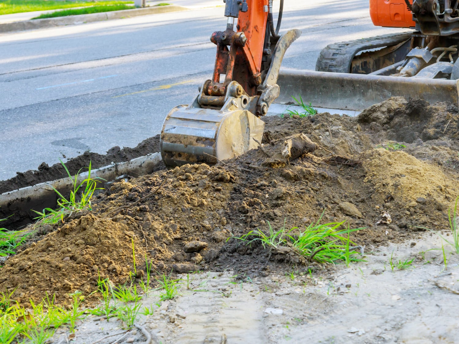 Digger working at construction in excavation pit